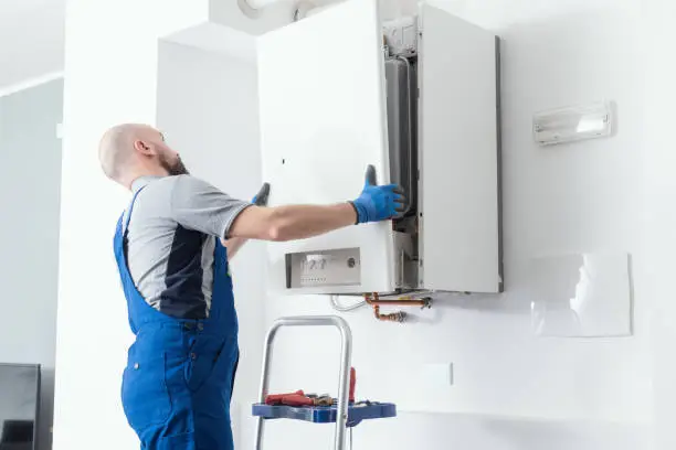 Technician testing water heater components and pressure controls with professional diagnostic equipment
