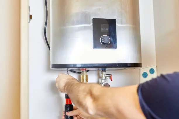 Technician restoring hot water to Atascadero home after morning water heater failure
